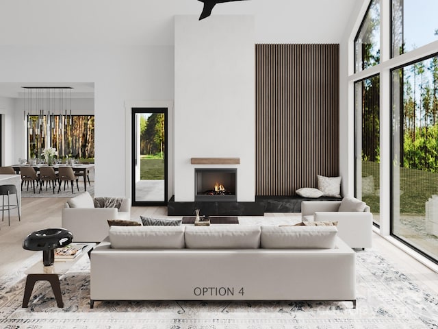 3 Bridgeway Dr Unit 38, Candler, NC 28715 - living area featuring wood finished floors, plenty of natural light, a lit fireplace, and a towering ceiling