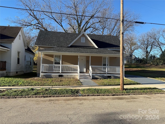 view of front of property with a front yard and a porch