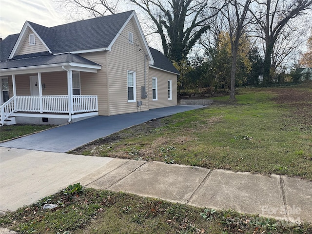 view of home's exterior featuring a yard and a porch