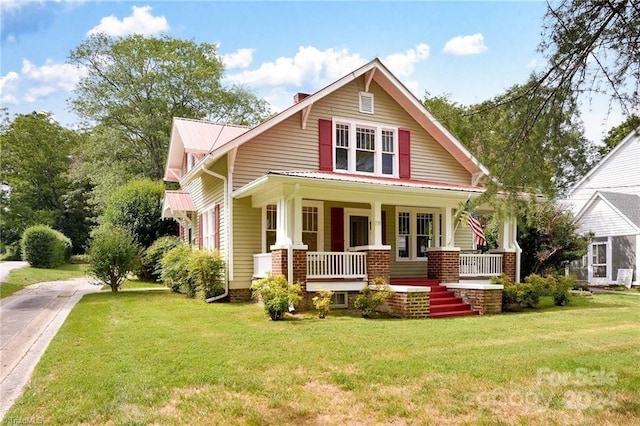 view of front facade with covered porch and a front lawn