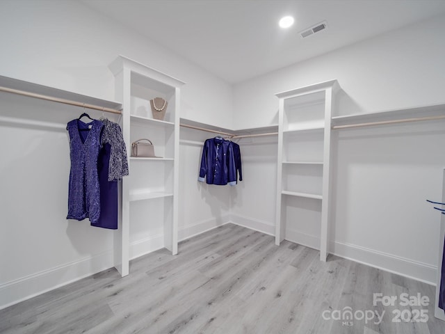 walk in closet featuring light hardwood / wood-style flooring