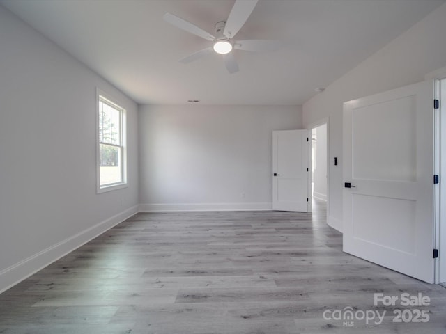 spare room featuring ceiling fan and light wood-type flooring