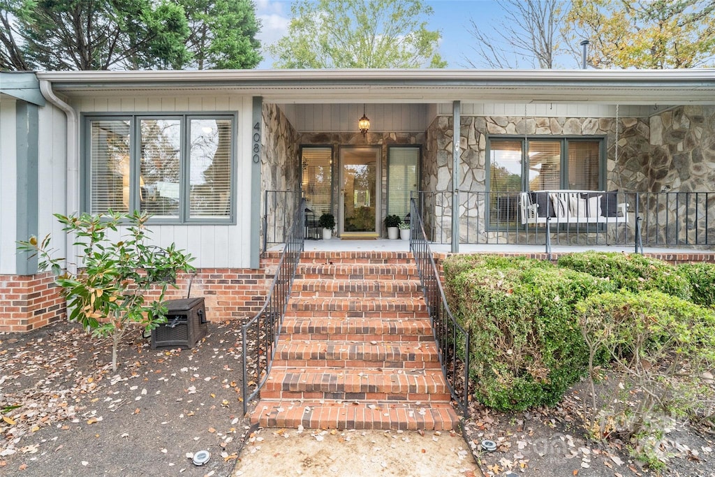 view of exterior entry featuring a porch