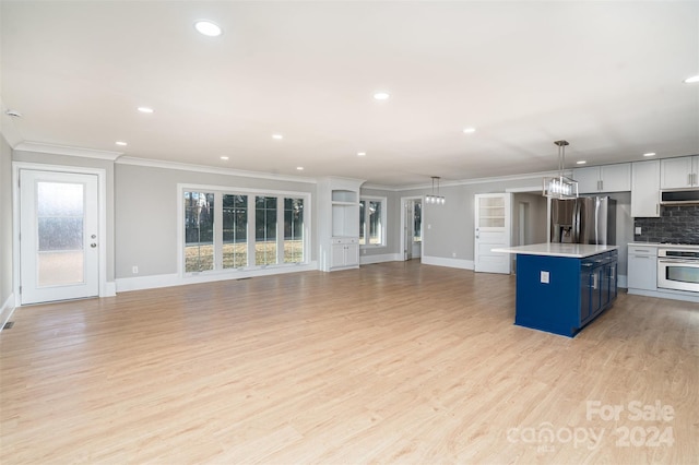 kitchen featuring white cabinetry, hanging light fixtures, blue cabinets, a kitchen island, and appliances with stainless steel finishes