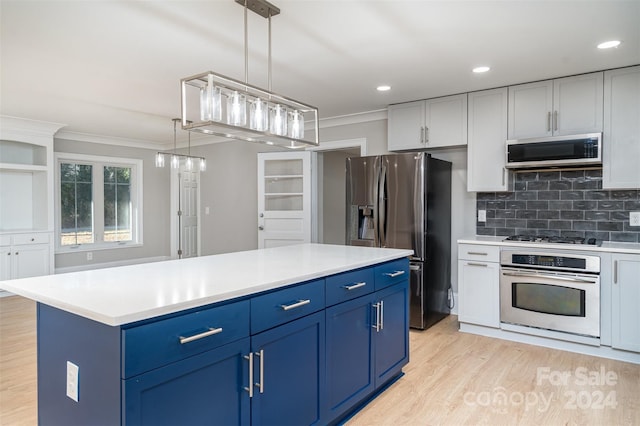 3700 Pinecrest Dr, Gastonia, NC 28056 - kitchen featuring appliances with stainless steel finishes, ornamental molding, blue cabinetry, light wood-style floors, and light countertops