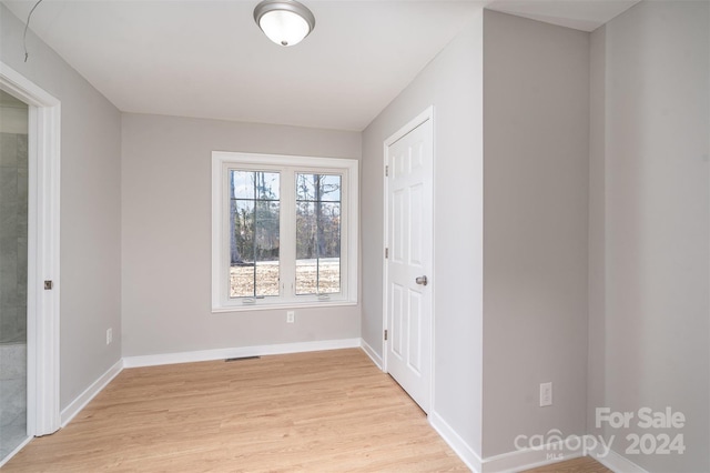 unfurnished room featuring light hardwood / wood-style floors