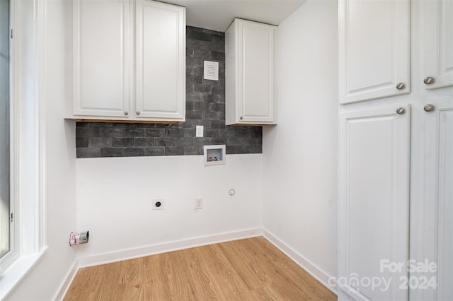 laundry room featuring cabinets, washer hookup, light wood-type flooring, and electric dryer hookup