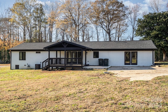 back of house featuring a lawn, cooling unit, and a patio