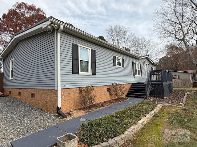 view of side of home with a wooden deck