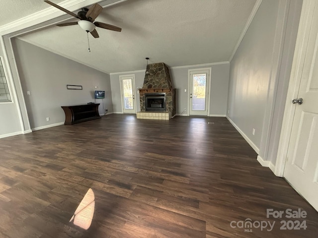 unfurnished living room featuring ceiling fan, dark wood-type flooring, crown molding, a textured ceiling, and a fireplace