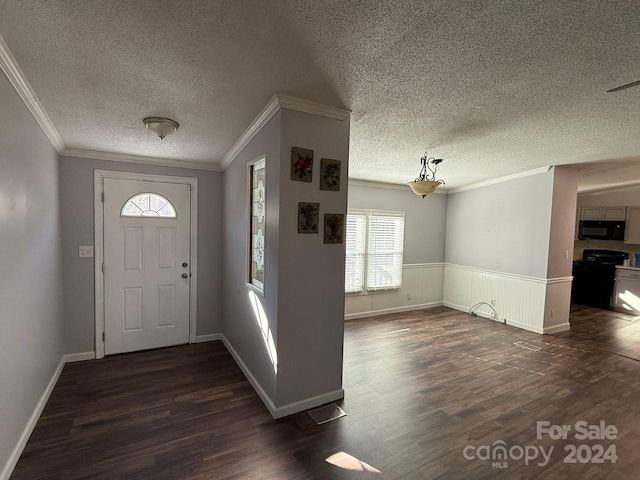 foyer featuring a textured ceiling, dark hardwood / wood-style floors, and ornamental molding