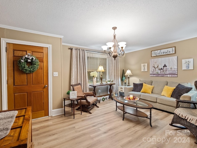 living room with a textured ceiling, light wood-type flooring, crown molding, and a notable chandelier