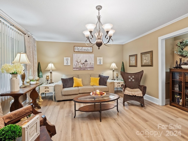 living room featuring a chandelier, ornamental molding, and light wood-type flooring