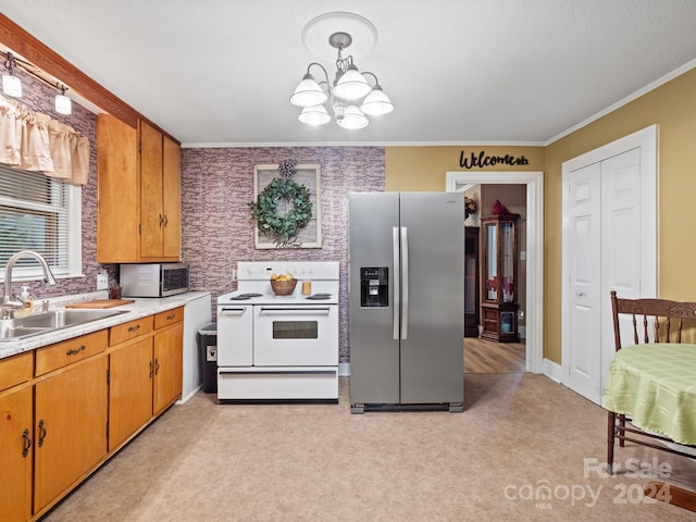 kitchen featuring light carpet, hanging light fixtures, sink, appliances with stainless steel finishes, and a chandelier