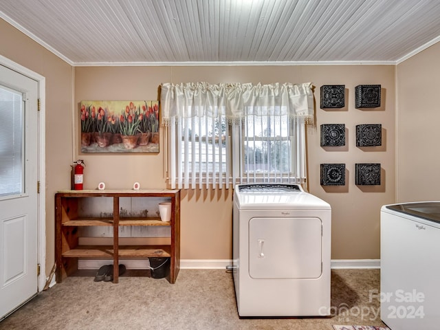 laundry room with light colored carpet, independent washer and dryer, and crown molding