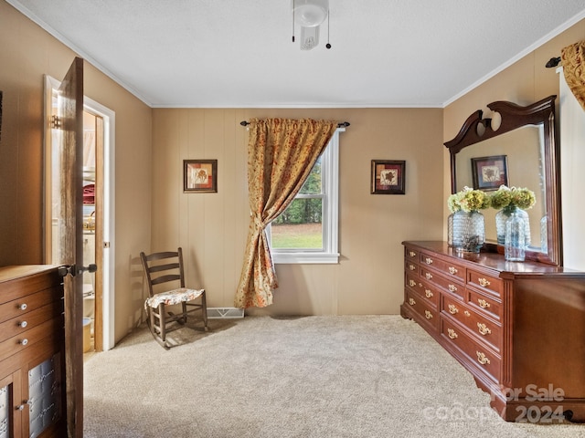 sitting room featuring a textured ceiling, carpet floors, and crown molding