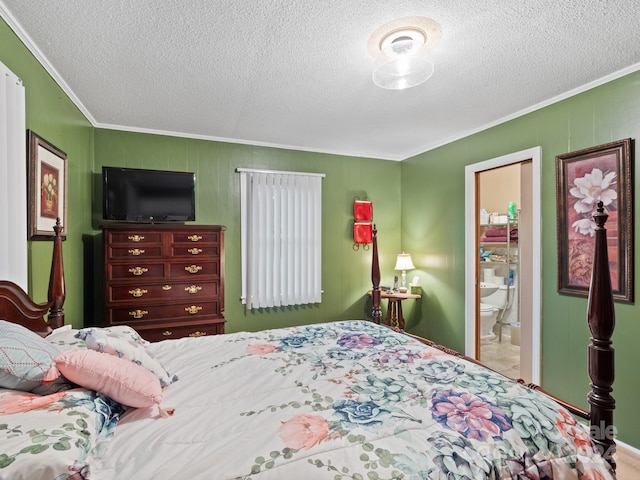 bedroom with connected bathroom, a textured ceiling, and ornamental molding