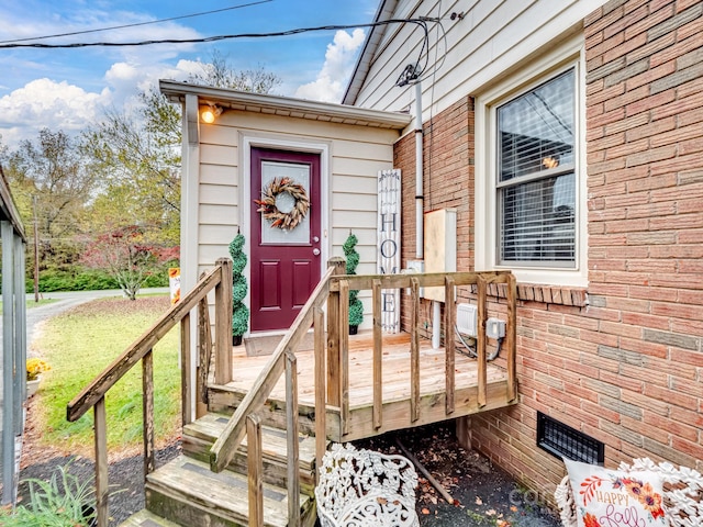 view of exterior entry featuring a yard