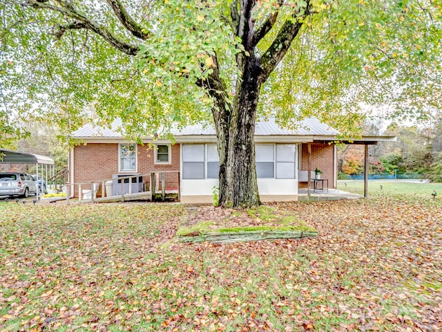 back of property with a carport