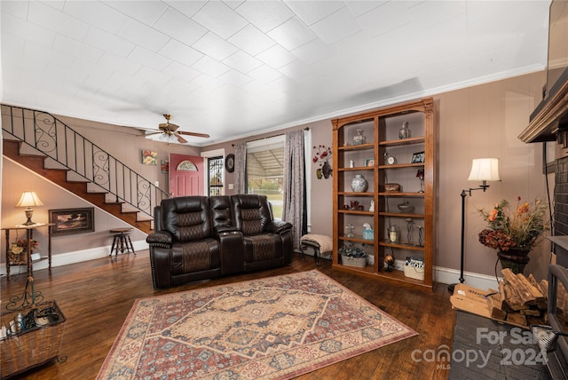 living room with crown molding, ceiling fan, and dark hardwood / wood-style floors