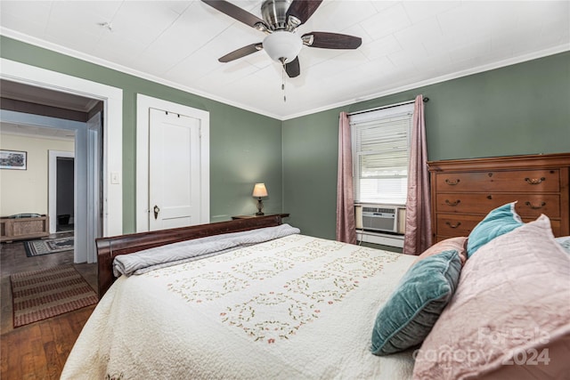 bedroom with dark hardwood / wood-style floors, ceiling fan, and ornamental molding