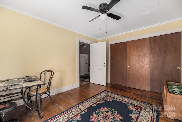 home office featuring dark hardwood / wood-style flooring, ceiling fan, and ornamental molding