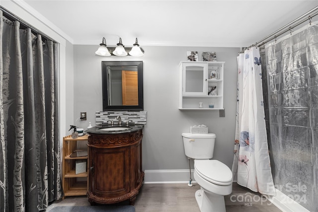 bathroom featuring hardwood / wood-style flooring, vanity, curtained shower, and toilet