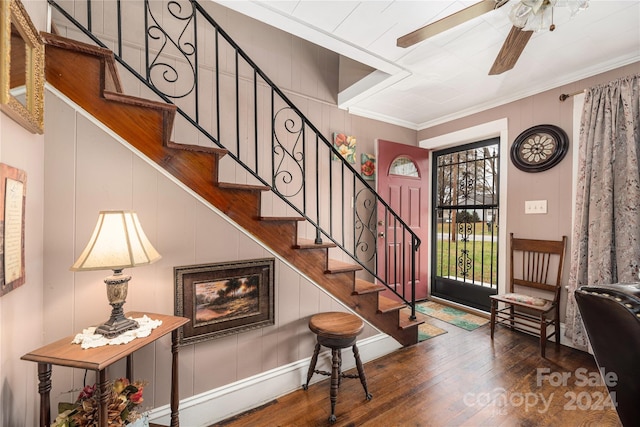 foyer entrance with ceiling fan, ornamental molding, and hardwood / wood-style flooring