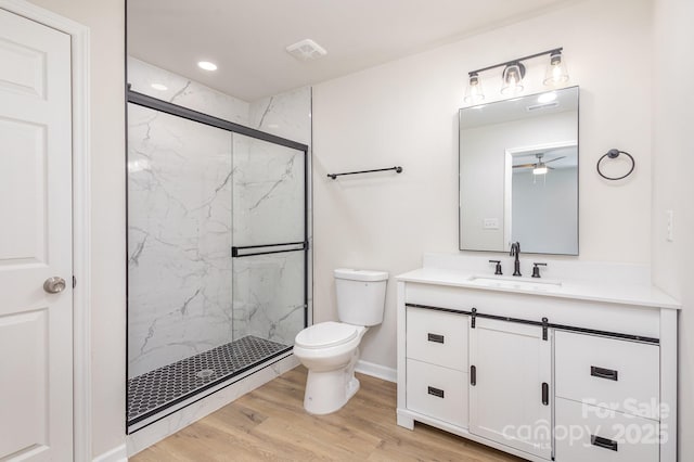 bathroom with walk in shower, toilet, vanity, and hardwood / wood-style flooring