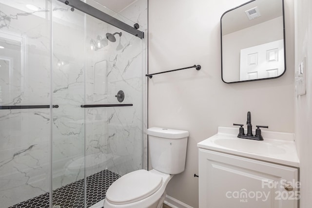 bathroom featuring vanity, toilet, and a shower with door