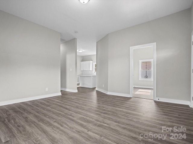 unfurnished living room featuring dark hardwood / wood-style floors