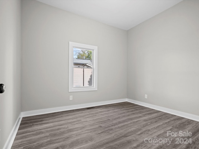 spare room with dark hardwood / wood-style floors