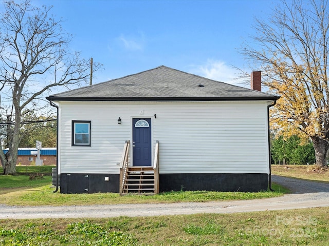 rear view of property with a lawn