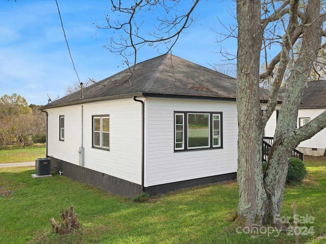 view of home's exterior featuring a yard and central air condition unit