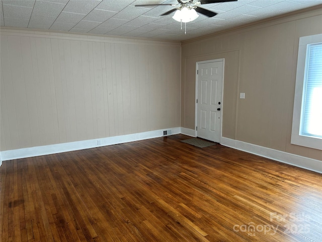 spare room featuring ceiling fan, ornamental molding, and wood-type flooring