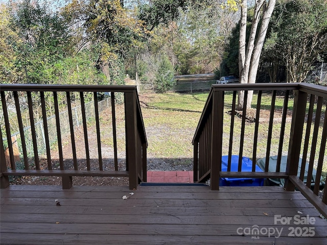 wooden deck featuring a yard