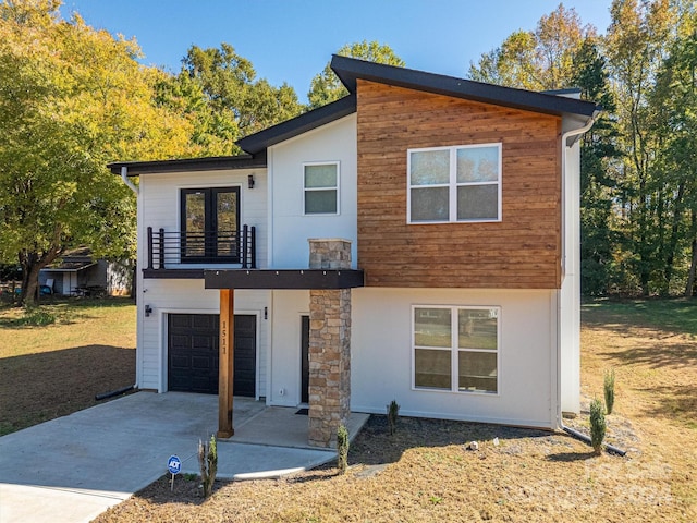 contemporary home featuring a balcony and a garage