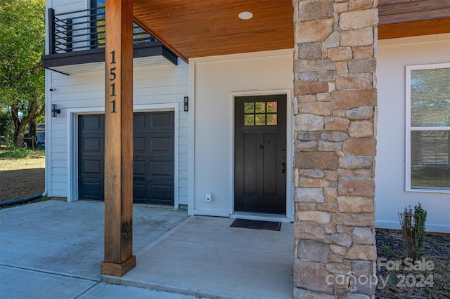 entrance to property with a balcony