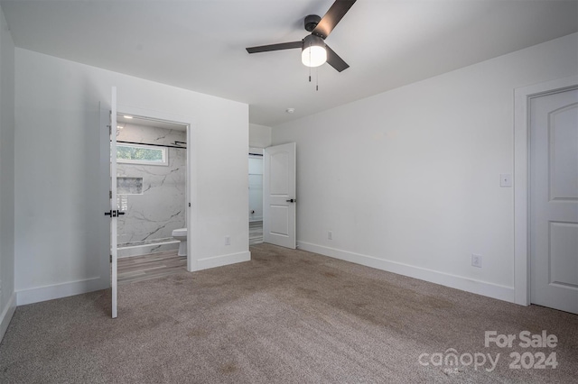 unfurnished bedroom featuring ceiling fan, light carpet, and connected bathroom