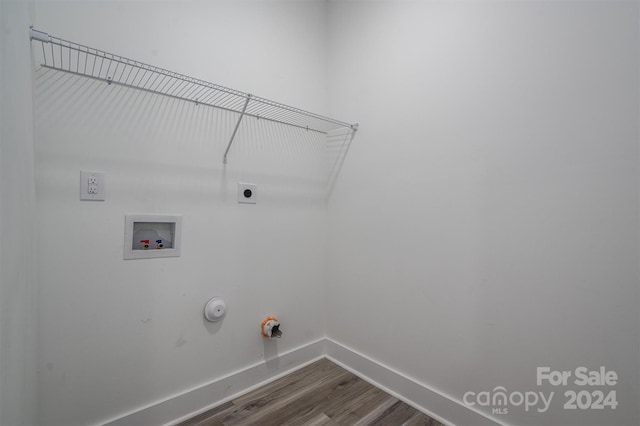 washroom with washer hookup, hardwood / wood-style flooring, hookup for a gas dryer, and electric dryer hookup