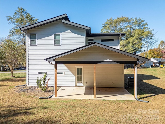 rear view of house with a yard and a patio area