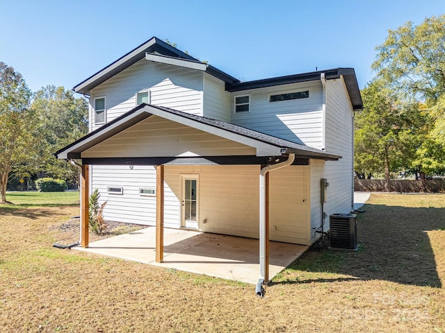 back of house featuring a yard, a patio, and central AC