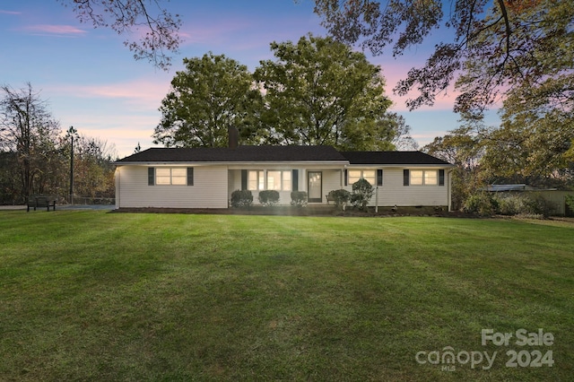 ranch-style house with a lawn