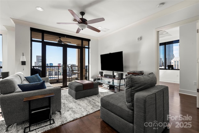 living room featuring ceiling fan, dark wood-type flooring, and a wall of windows