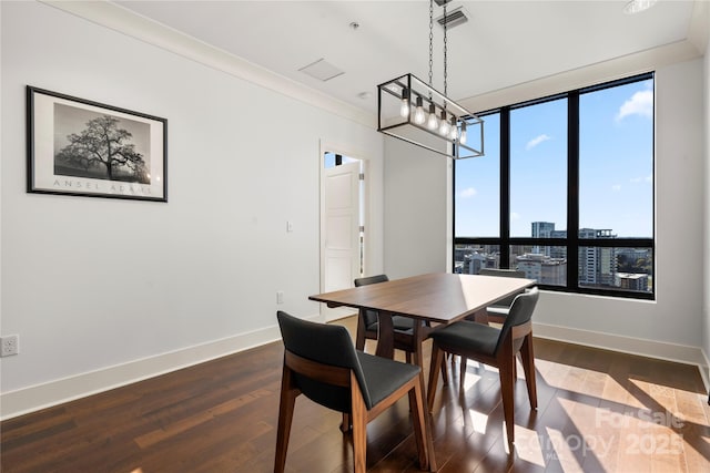 dining room featuring dark hardwood / wood-style flooring and crown molding