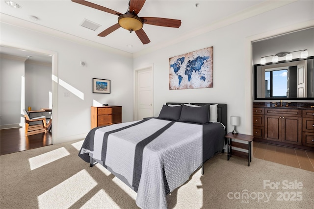 bedroom with ceiling fan, sink, ornamental molding, and light carpet