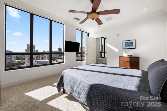 carpeted bedroom with ceiling fan and crown molding