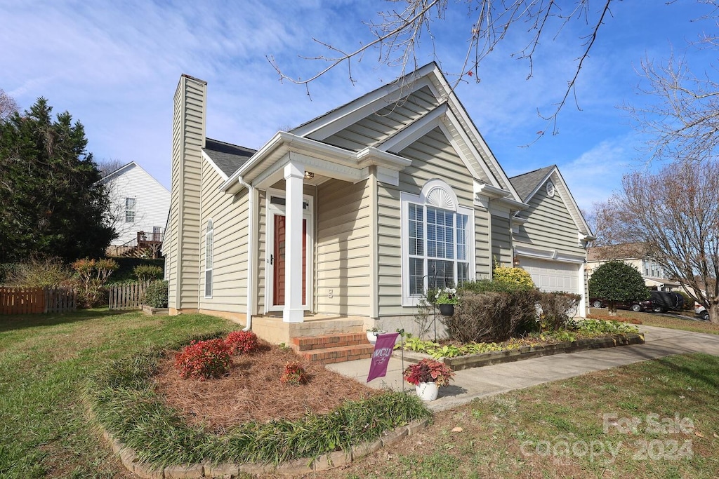 view of front of house with a front yard and a garage