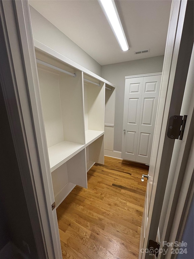 walk in closet featuring light hardwood / wood-style floors