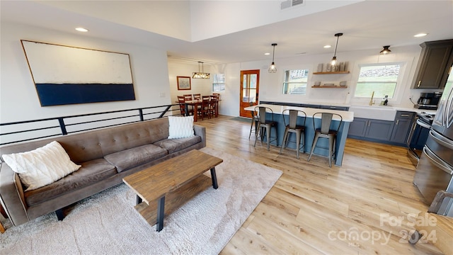 living room featuring light hardwood / wood-style flooring and sink